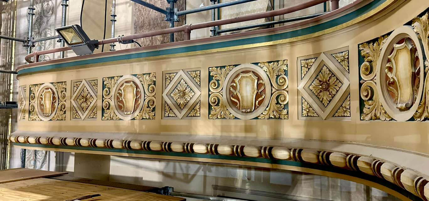 Image of Ornate balcony decorations being restored